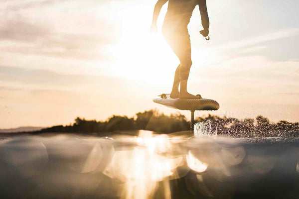 Fliteboard eFoil with sun reflecting over water